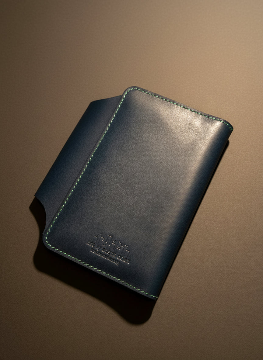 Navy leather pocket journal cover back showing Art by Steph Chan brand stamp and green stitching