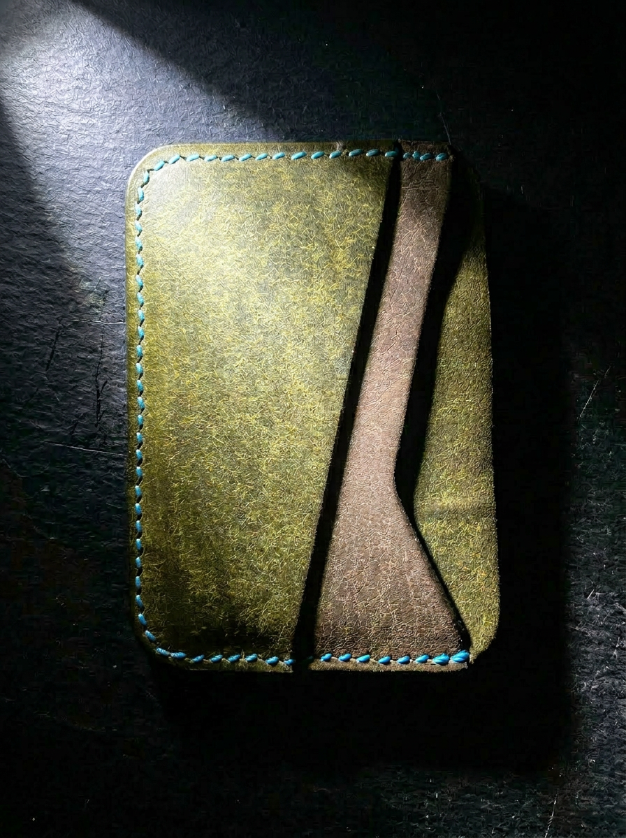 The Landscape Card Holder interior showing olive and gray Pueblo leather with turquoise hand stitching